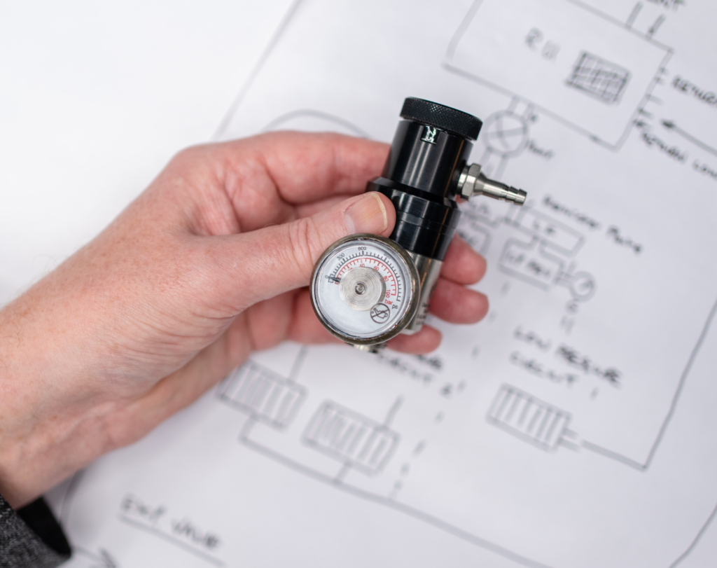 Hand holding a precision engineered equipment for the speciality gas industry